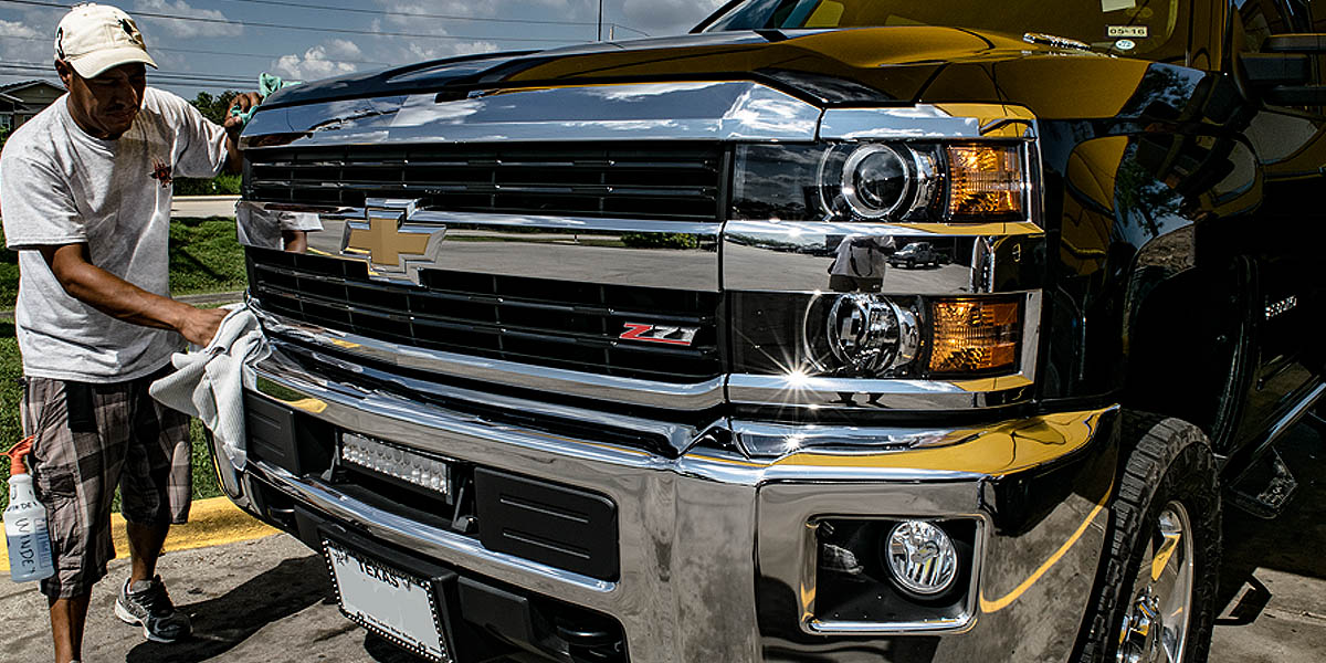 Hugh and Jeff's team hand detailing a clean pickup truck